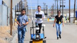 During a recent road closure, Florida International University students (left to right) Jeff Natividad, Joel Adams and Thi Tran test a radiation mapping robot outside of U Farm