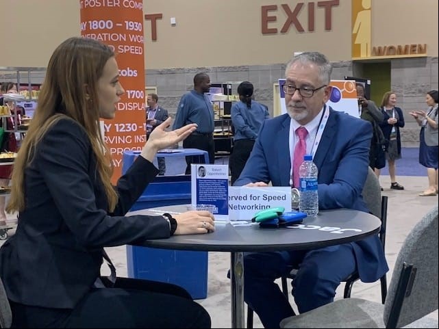 (L to R) Ms. Olivia Bustillo speaking with Mr. Jay Mullis (Acting Associate Principal Deputy Assistant Secretary for Regulatory and Policy Affairs, DOE-EM) at the Speed Networking Event